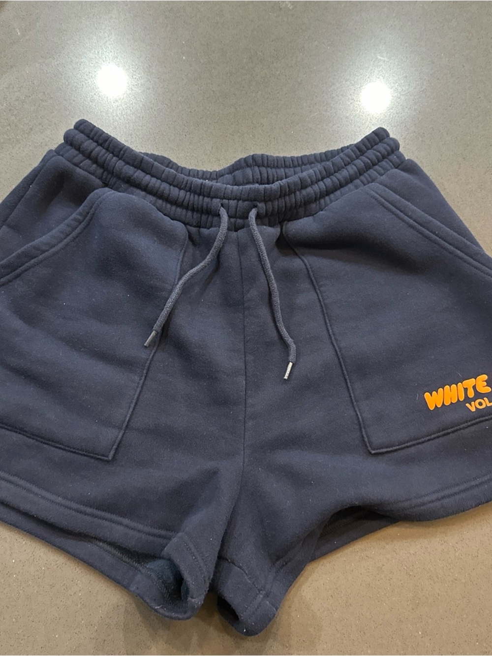 White Fox Boutique Navy Fleece Drawstring Shorts with Yellow Logo